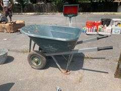 Green Polyethylene Wheelbarrow With Metal Frame and Dual Wheels