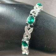 Green CZ silvertone X&O bracelet 7-8in