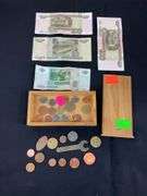 Wooden box with foreign coins and four foreign bills