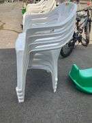 Four White Plastic Stackable Patio Chairs