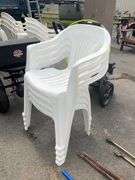 Four White Stackable Plastic Patio Chairs