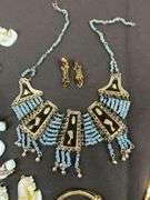 Egyptian style jewelry with bib necklace, necklace with matching earrings, goldtone necklace, clip on earrings, and a Wittnauer wrist watch not running