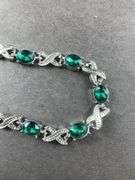 Green CZ silvertone X&O bracelet 7-8in