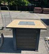 Propane Firepit with Lava Rocks and Woven Cabinet Design