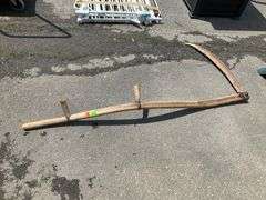 Two-Handed Scythe With Curved Wooden Handle and Metal Blade