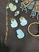 Egyptian style jewelry with bib necklace, necklace with matching earrings, goldtone necklace, clip on earrings, and a Wittnauer wrist watch not running