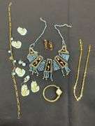 Egyptian style jewelry with bib necklace, necklace with matching earrings, goldtone necklace, clip on earrings, and a Wittnauer wrist watch not running