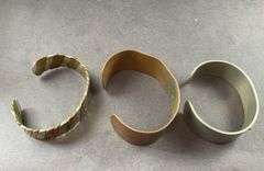 Three Cuff Bracelets One of Copper, One Copper And Silvertone, One Heavy Silver Tone