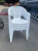 Four White Plastic Stackable Patio Chairs