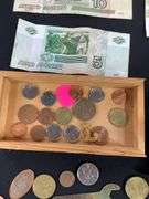 Wooden box with foreign coins and four foreign bills