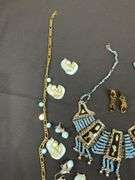 Egyptian style jewelry with bib necklace, necklace with matching earrings, goldtone necklace, clip on earrings, and a Wittnauer wrist watch not running