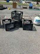 Four Black Plastic Crates With Cracked Features