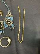 Egyptian style jewelry with bib necklace, necklace with matching earrings, goldtone necklace, clip on earrings, and a Wittnauer wrist watch not running