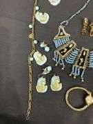 Egyptian style jewelry with bib necklace, necklace with matching earrings, goldtone necklace, clip on earrings, and a Wittnauer wrist watch not running