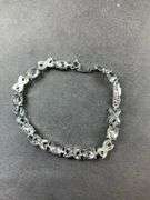 Green CZ silvertone X&O bracelet 7-8in
