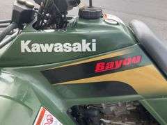 Kawasaki Bayou 300 4-Wheeler, 4x4. Front 4 foot blade and winch.