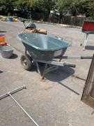 Green Polyethylene Wheelbarrow With Metal Frame and Dual Wheels
