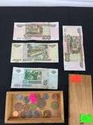Wooden box with foreign coins and four foreign bills