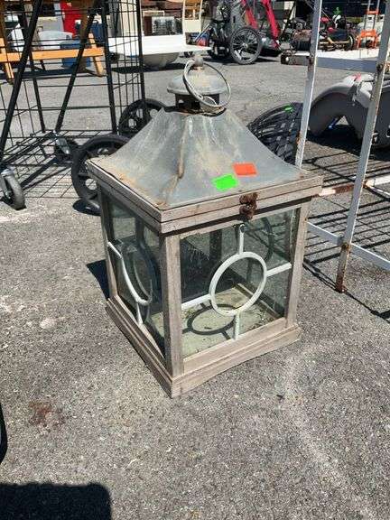 Outdoor Lantern Candle Holder, approximately 10x10x18” tall. Wood framed with metal roofing.