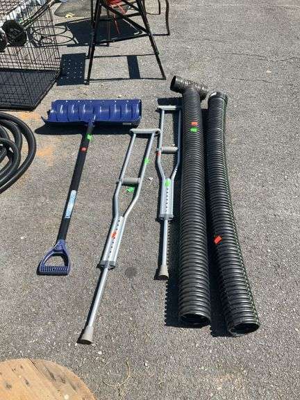Miscellaneous items lot, set of crutches, snow shovel, two 5 foot sections of black drain pipe.