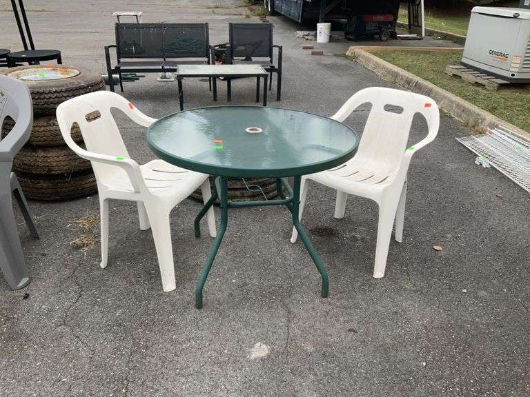 3pc Outdoor Furniture lot. 2-white poly chairs with 35” Glass round top table aluminum framed, mismatched set.