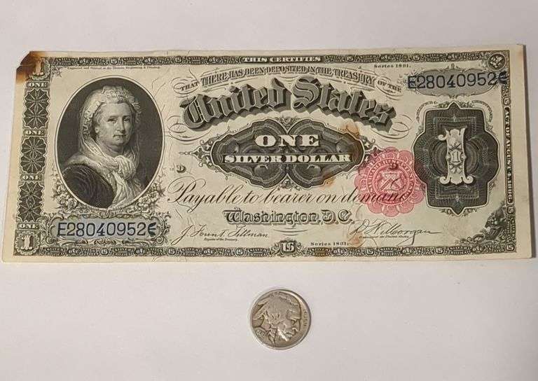U. S. One Silver Dollar Bill and a Buffalo Nickel Coin
