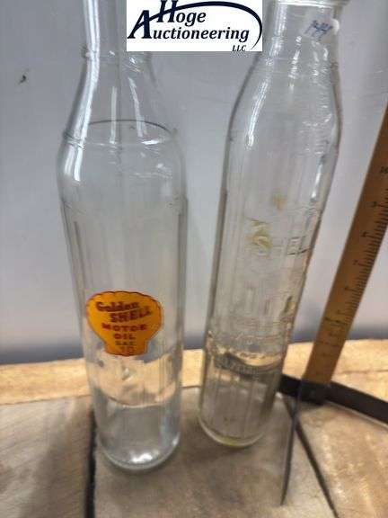 2 glass oil bottles. 1 embossed Shell-Penn Motor Oil (1 quart), 1 Golden Shell Motor Oil (1 quart).