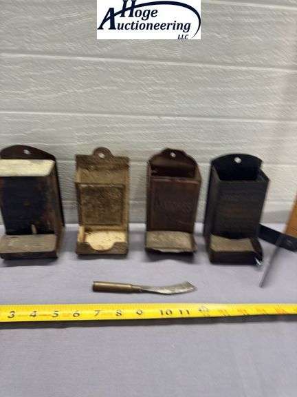 4 tin hanging matchboxes and homemade tool. 1 Zephyr Flour, 1 Fred Karle Furniture and Undertaking K
