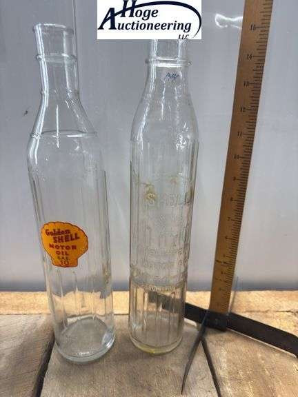 2 glass oil bottles. 1 embossed Shell-Penn Motor Oil (1 quart), 1 Golden Shell Motor Oil (1 quart).