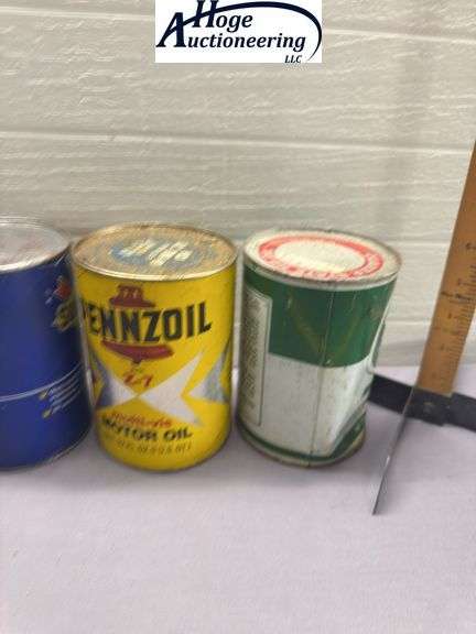 6 one quart oil cans. 3 Quaker State, 2 Pennzoil, 1 Sunoco