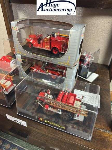 Bottom Shelf - model fire trucks in display boxes, Texaco fire helmet. (trucks include Ford, Packard