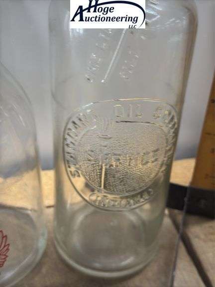 2 one quart glass oil bottles.1 embossed Standard Oil Company Service (Indiana), 1 Huffman Mfg Compa