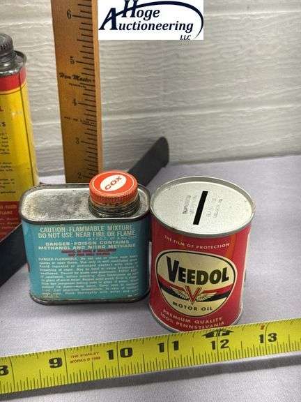 6 cans. Glow fuel and oil. 1 Veedol bank, 1 Structo bank, 1 Wolf's head bank, 1 Cox, 2 O.K. Cub
