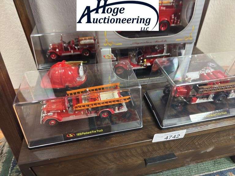 Bottom Shelf - model fire trucks in display boxes, Texaco fire helmet. (trucks include Ford, Packard