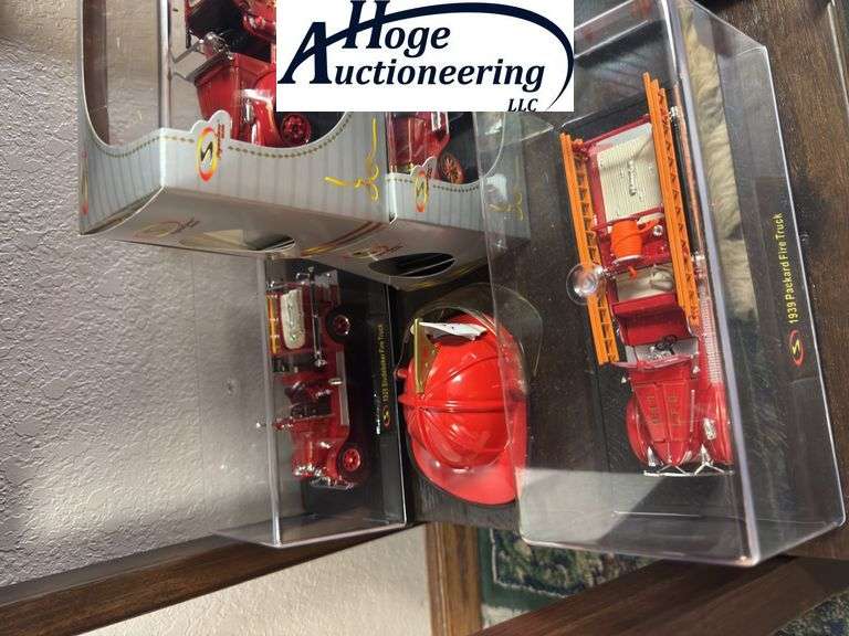 Bottom Shelf - model fire trucks in display boxes, Texaco fire helmet. (trucks include Ford, Packard