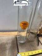 2 glass oil bottles. 1 embossed Shell-Penn Motor Oil (1 quart), 1 Golden Shell Motor Oil (1 quart).