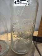2 one quart glass oil bottles.1 embossed Standard Oil Company Service (Indiana), 1 Huffman Mfg Compa