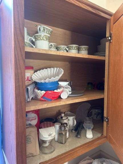 Contents of cabinet - mugs/coffee supplies