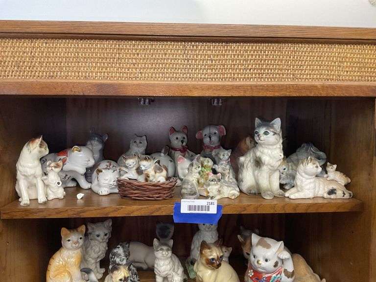 Contents of shelf: cat and dog figurines