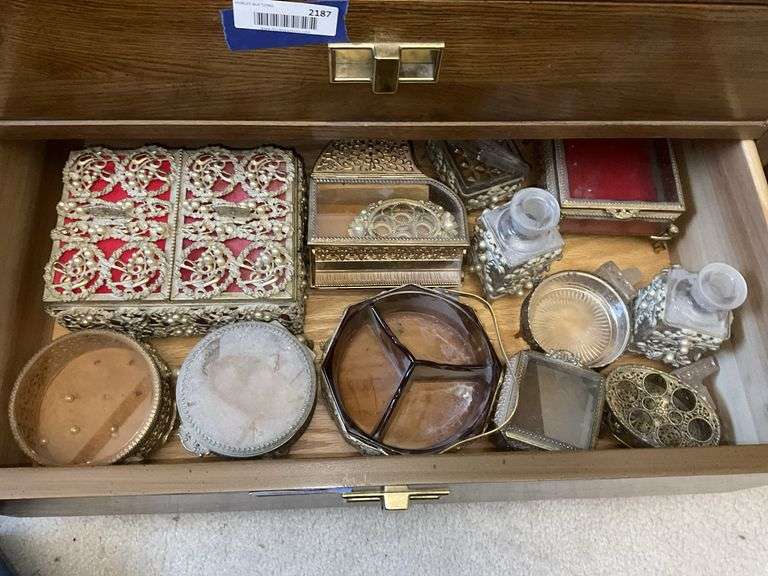 Contents of drawer: jewelry boxes, dresser boxes, cologne bottles