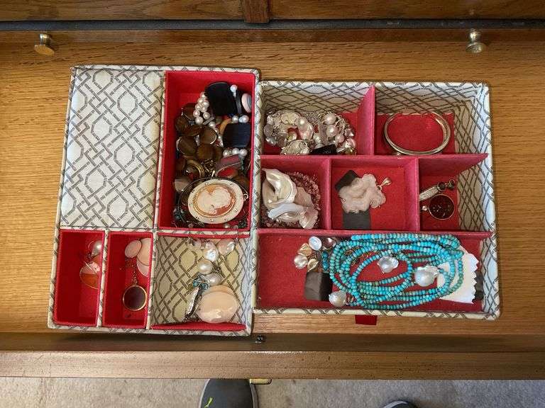 Two trays of jewelry: bracelet, earrings, pendant
