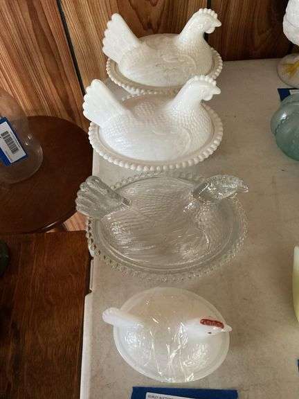 Three glass hen on nest covered dishes: two milk glass, one clear