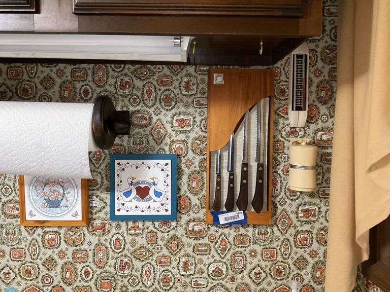 Wall hangings: Oneida knife set in rack, tiles, paper towel holder, thermometer