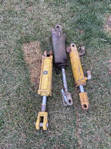 Three John Deere hydraulic cylinders