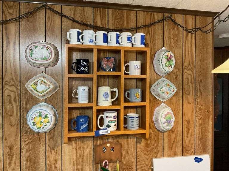 Wall what-not shelf and mug contents, decorative ceramic molds