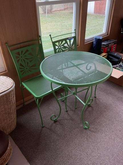 Green metal patio table and pair of matching chairs