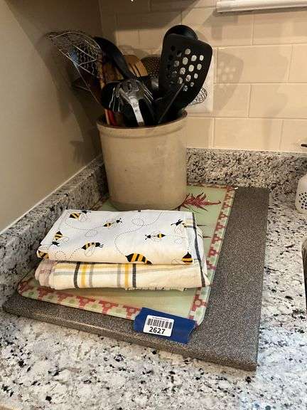 Stoneware crock w/ kitchen utensils, cutting boards, tablecloths,