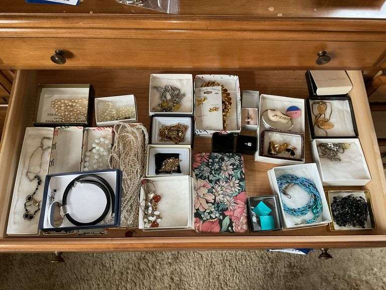 Contents of drawer: costume jewelry pearls, necklaces