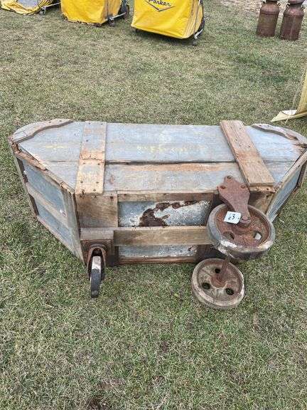 Antique feed cart marked The Favorite. Bottom rusted out.