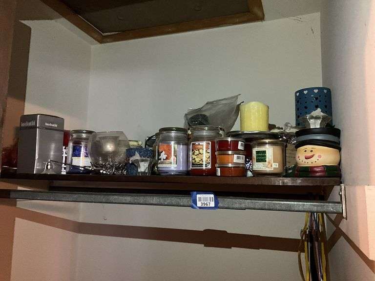 Contents of shelf: jar candles, candles, candleholders